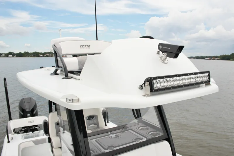 Slide: The Image of 2023 Costa Custom Boats 264 HC on water, featuring sleek design and advanced equipment. - 60