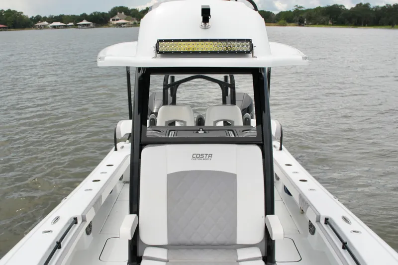 Slide: The Image of 2023 Costa Custom Boats 264 HC on water, showcasing sleek design and seating. - 35