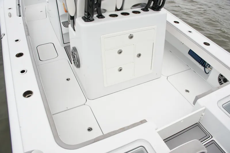 Slide: The Image of 2023 Costa Custom Boats 264 HC deck with storage compartments and rod holders. - 49