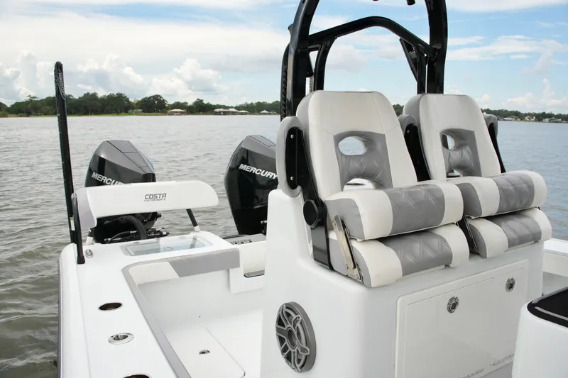 Slide: The Image of 2023 Costa Custom Boats 264 HC with dual Mercury engines on a calm lake. - 41