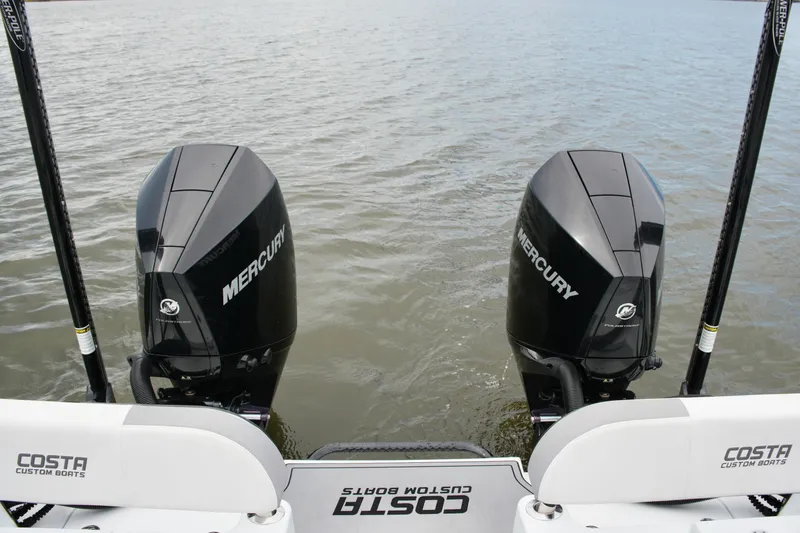 Slide: The Image of 2023 Costa Custom Boats 264 HC with dual Mercury outboard engines on water. - 57
