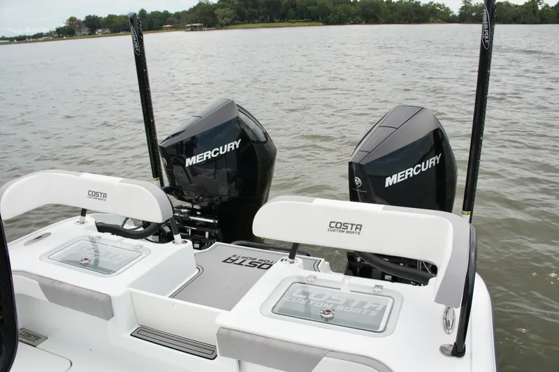 Slide: The Image of 2023 Costa Custom Boats 264 HC with dual Mercury engines on a calm lake. - 54