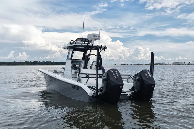 Slide: The Image of 2023 Costa Custom Boats 264 HC on water, featuring dual Mercury engines. - 17