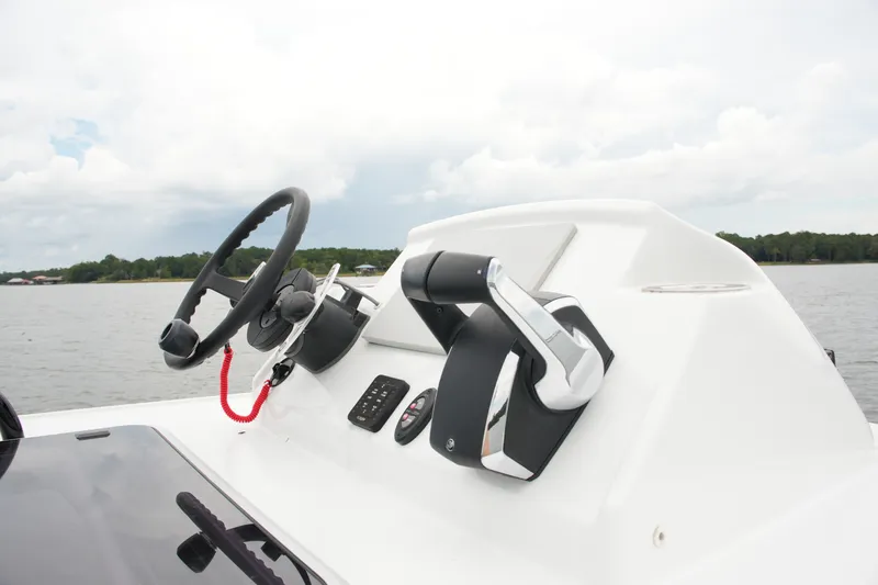 Slide: The Image of Steering console of 2023 Costa Custom Boats 264 HC on a calm lake. - 67