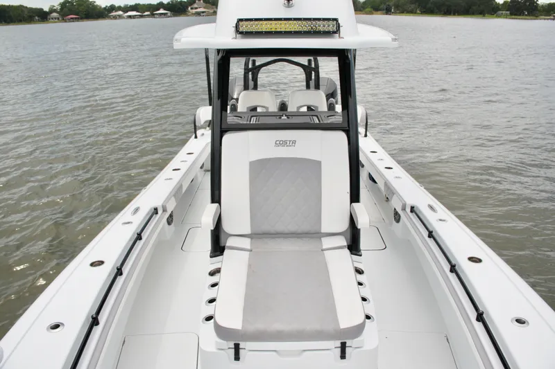 Slide: The Image of 2023 Costa Custom Boats 264 HC on water, showcasing sleek design and seating. - 34