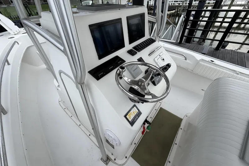 Slide: The Image of 2007 Cape Horn 24OS boat cockpit with dual screens and steering wheel. - 18