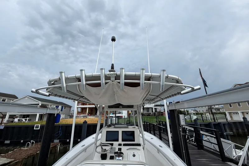 Slide: The Image of 2007 Cape Horn 24OS boat docked under cloudy skies, featuring a central console. - 19