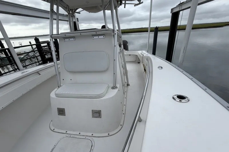Slide: The Image of 2007 Cape Horn 24OS boat interior with seating and railing, docked by calm waters. - 14