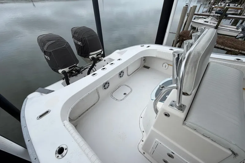 Slide: The Image of 2007 Cape Horn 24OS boat with dual Suzuki engines, docked at marina. - 22