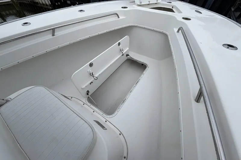 Slide: The Image of 2007 Cape Horn 24OS boat interior with open storage compartment and seating. - 15