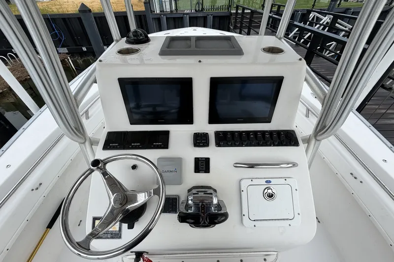 Slide: The Image of Center console of a 2007 Cape Horn 24OS boat with dual screens and controls. - 17