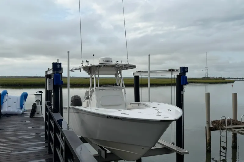 Slide: The Image of 2007 Cape Horn 24OS boat on lift at dock, overcast sky. - 23