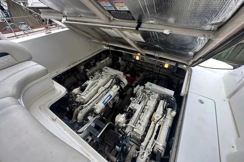 Slide: The Image of Engine compartment of a 2003 Sea Ray 420 Sundancer yacht, showcasing dual engines. - 26