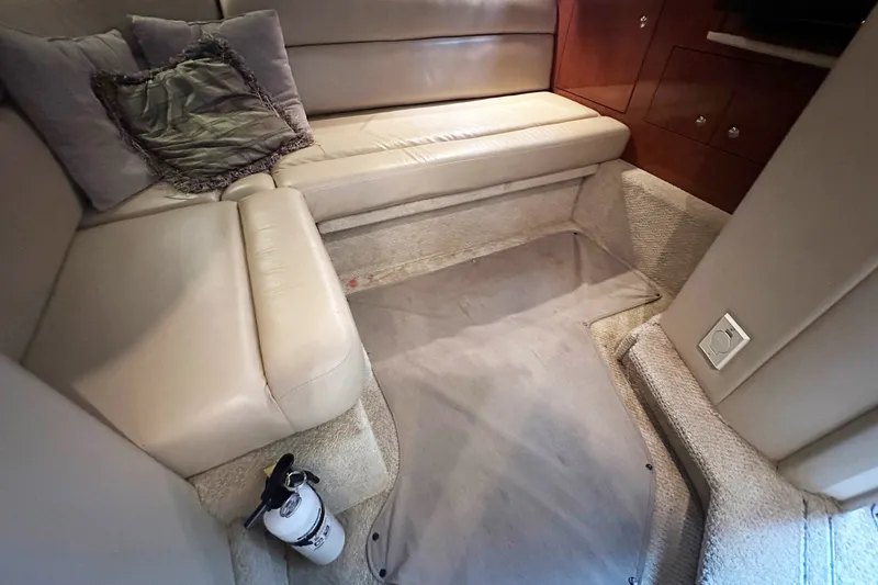 Slide: The Image of Interior of 2003 Sea Ray 420 Sundancer with beige seating and carpeted flooring. - 16