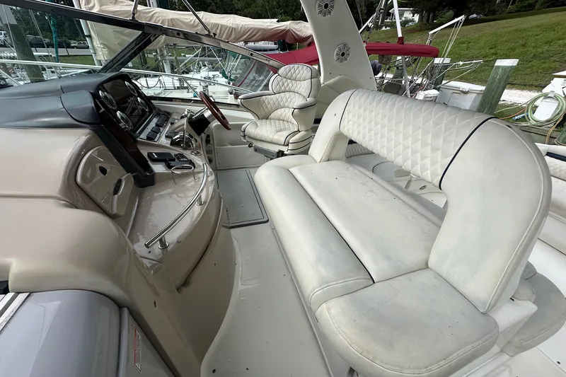 Slide: The Image of 2003 Sea Ray 420 Sundancer cockpit with beige seating and control panel. - 23