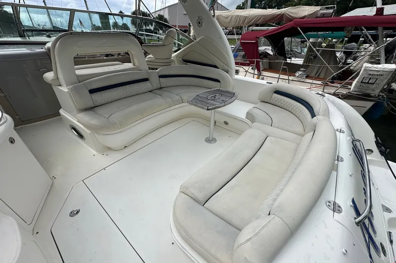 Slide: The Image of 2003 Sea Ray 420 Sundancer yacht with spacious white seating area and small table. - 25