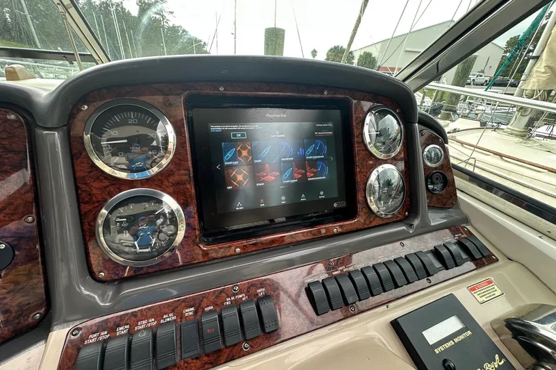 Slide: The Image of Dashboard of 2003 Sea Ray 420 Sundancer with gauges and touchscreen display. - 21