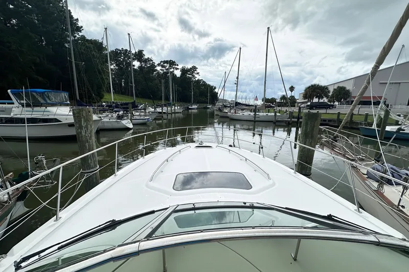 Slide: The Image of Bow view of 2003 Sea Ray 420 Sundancer docked in a marina. - 19
