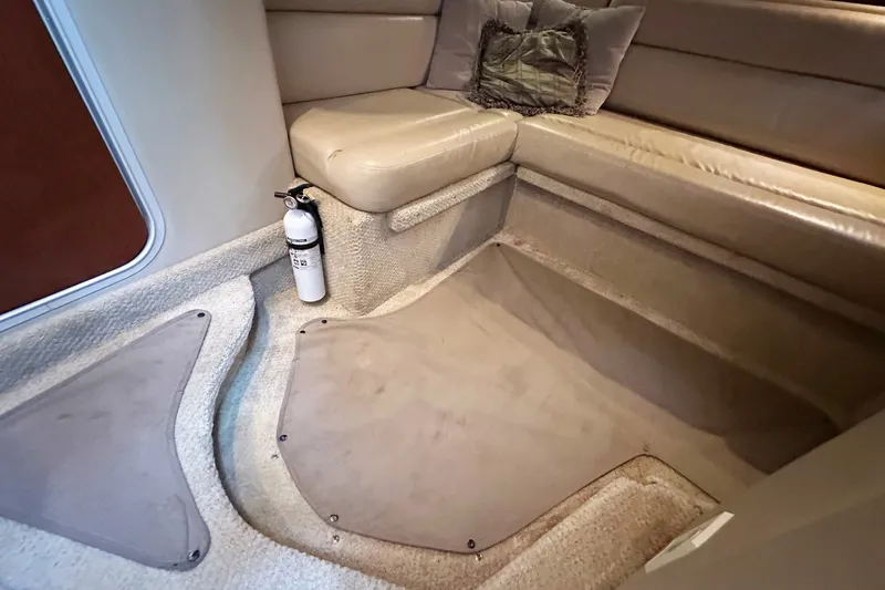 Slide: The Image of Interior of 2003 Sea Ray 420 Sundancer with beige seating and fire extinguisher. - 14