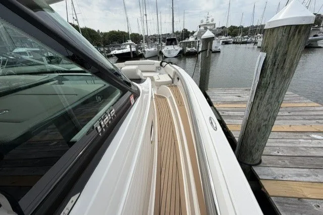 Slide: The Image of 2024 Tiara Yachts 48 LS docked, showcasing sleek design and teak decking. - 17