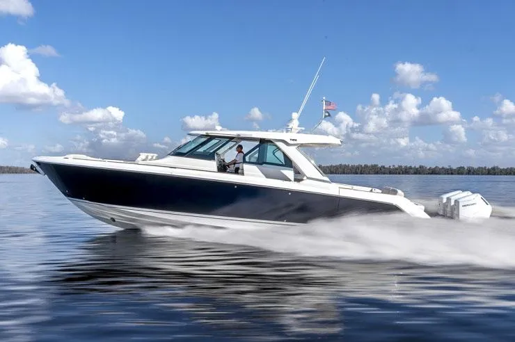 Slide: The Image of Manufacturer Provided Image: 2024 Tiara Yachts 48 LS cruising on calm waters under a clear blue sky. - 0