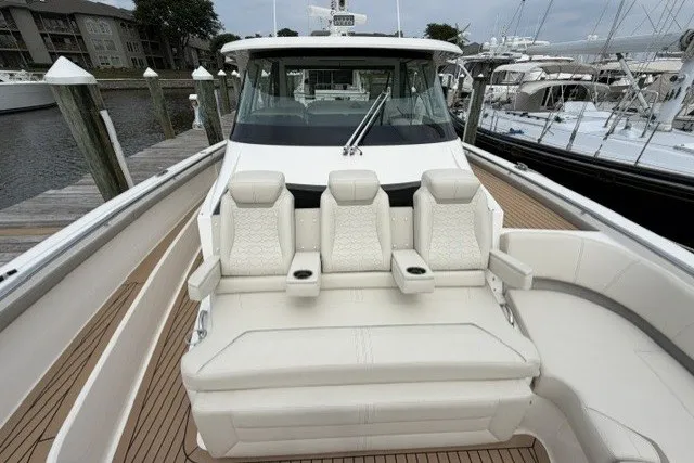 Slide: The Image of 2024 Tiara Yachts 48 LS luxury boat with plush seating and sleek design. - 20