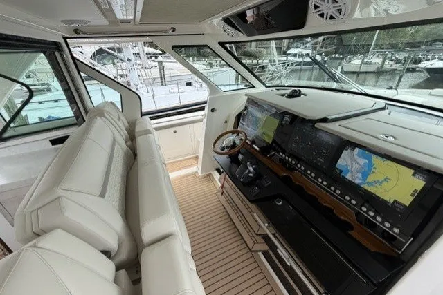 Slide: The Image of 2024 Tiara Yachts 48 LS helm with advanced navigation displays and luxurious seating. - 13