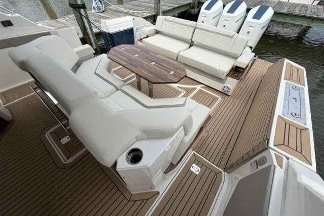 Slide: The Image of Luxurious seating area on 2024 Tiara Yachts 48 LS with elegant wood accents. - 7