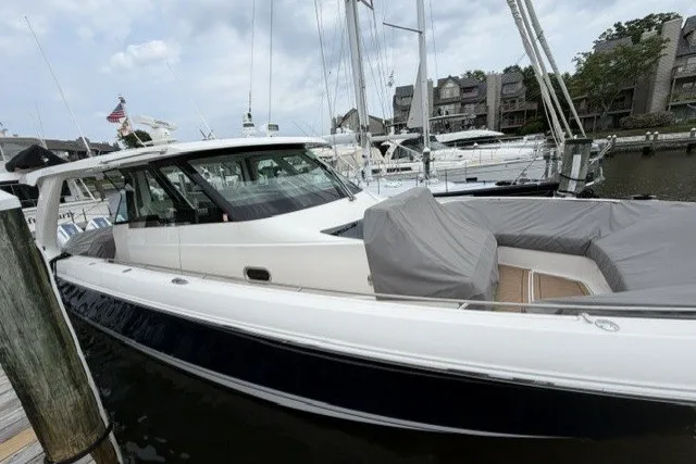 Slide: The Image of 2024 Tiara Yachts 48 LS docked at a marina, showcasing sleek design and luxury features. - 3