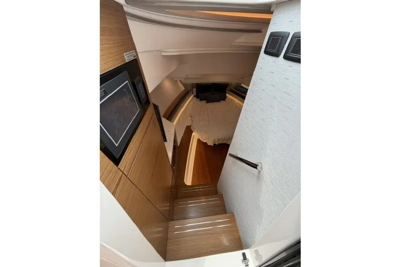 Slide: The Image of Luxurious interior of 2024 Tiara Yachts 48 LS, featuring elegant wood finishes and cozy sleeping area. - 22