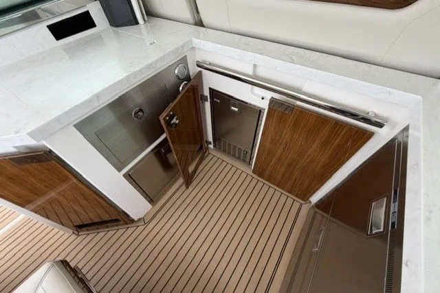 Slide: The Image of Luxurious interior of 2024 Tiara Yachts 48 LS, featuring sleek wood and stainless finishes. - 9