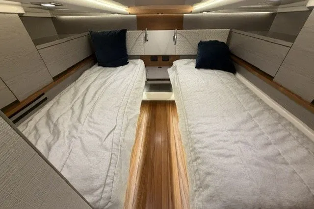 Slide: The Image of 2024 Tiara Yachts 48 LS cabin with twin beds and modern interior design. - 25