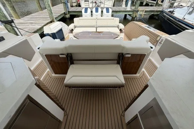 Slide: The Image of 2024 Tiara Yachts 48 LS luxury yacht deck with seating and wooden flooring. - 11
