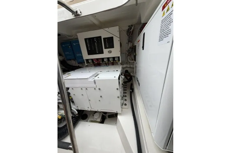 Slide: The Image of Engine room of 2024 Tiara Yachts 48 LS, showcasing electrical systems and components. - 28