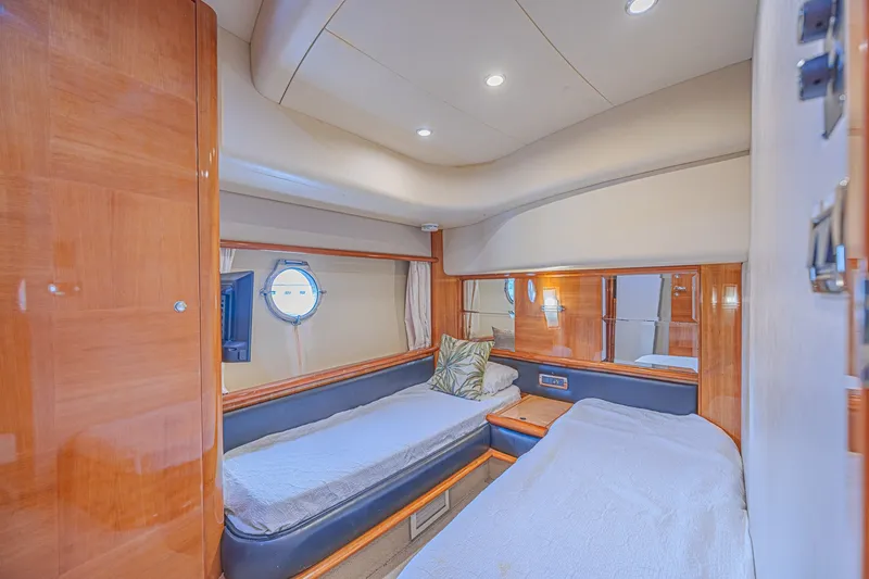 Slide: The Image of Luxurious 2008 Azimut 62 yacht cabin with twin beds and elegant wood paneling. - 50