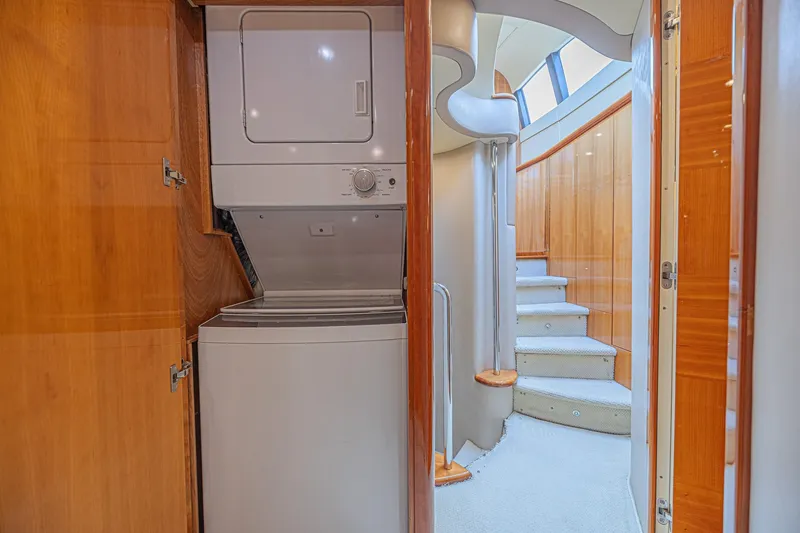 Slide: The Image of Laundry area and staircase inside a 2008 Azimut 62 yacht, featuring wood paneling. - 34
