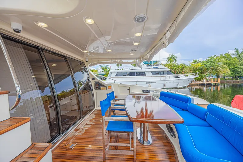 Slide: The Image of Luxurious 2008 Azimut 62 yacht deck with blue seating and wooden table. - 16