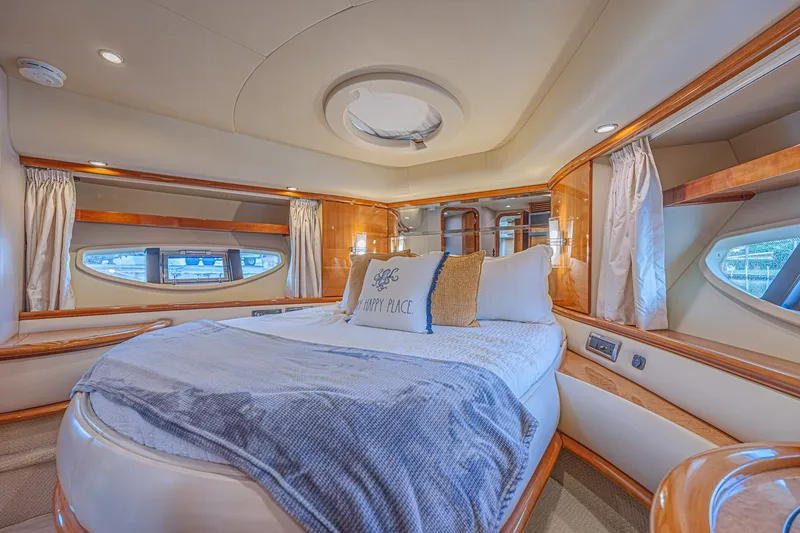 Slide: The Image of Luxurious bedroom interior of a 2008 Azimut 62 yacht with elegant wood finishes. - 40
