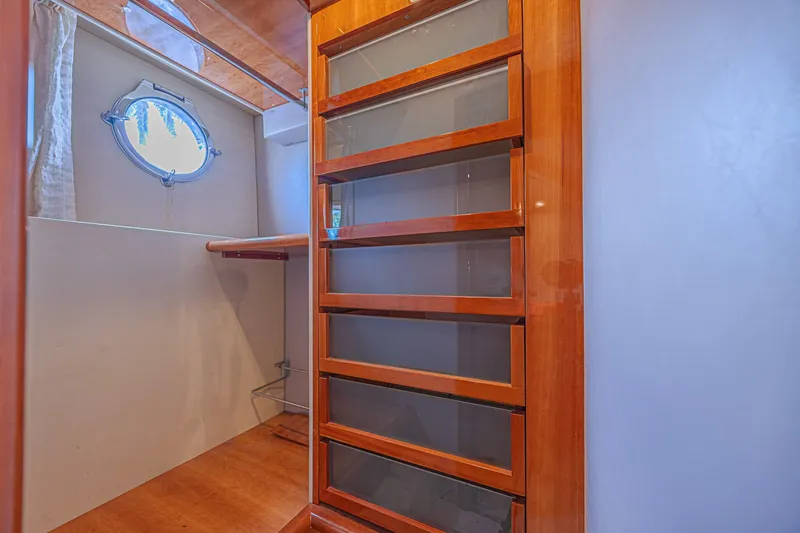 Slide: The Image of Interior of 2008 Azimut 62 yacht with wooden cabinetry and porthole window. - 57
