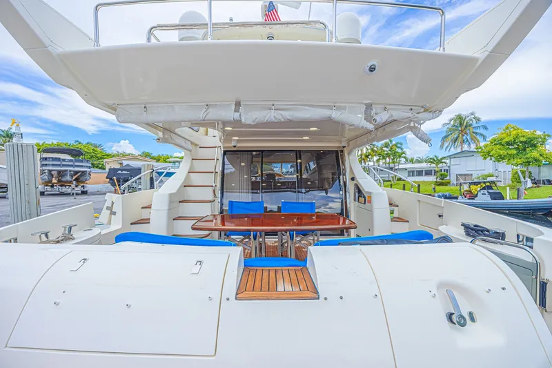 Slide: The Image of Luxurious 2008 Azimut 62 yacht with outdoor seating and dining area. - 63