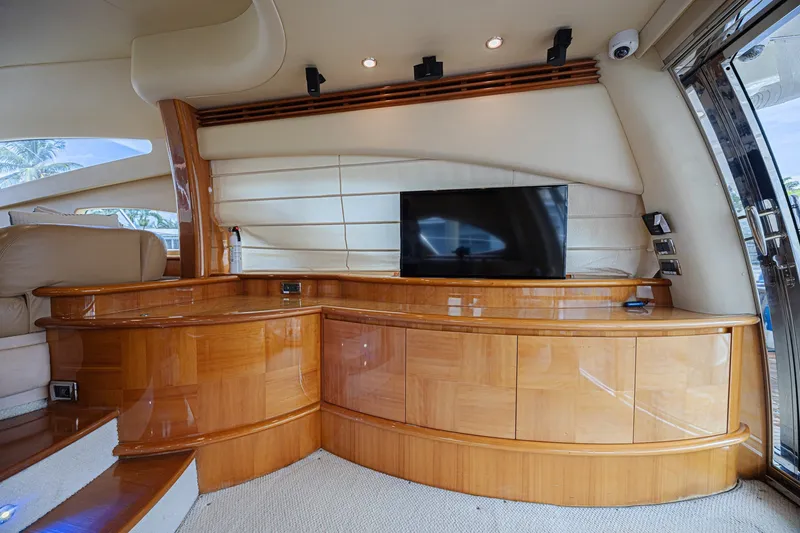 Slide: The Image of Luxurious interior of a 2008 Azimut 62 yacht with elegant wood cabinetry and modern TV setup. - 21