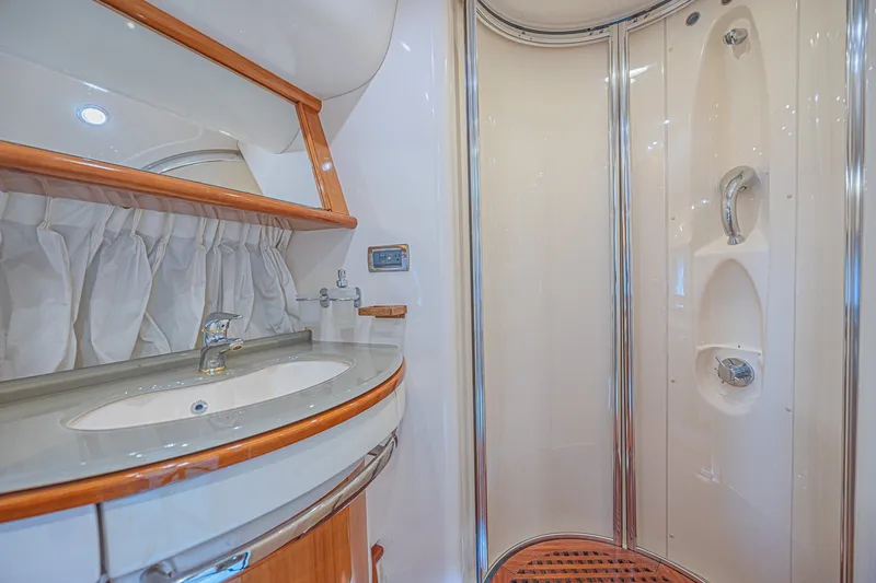 Slide: The Image of Luxurious bathroom in a 2008 Azimut 62 yacht, featuring a sleek shower and elegant sink. - 36