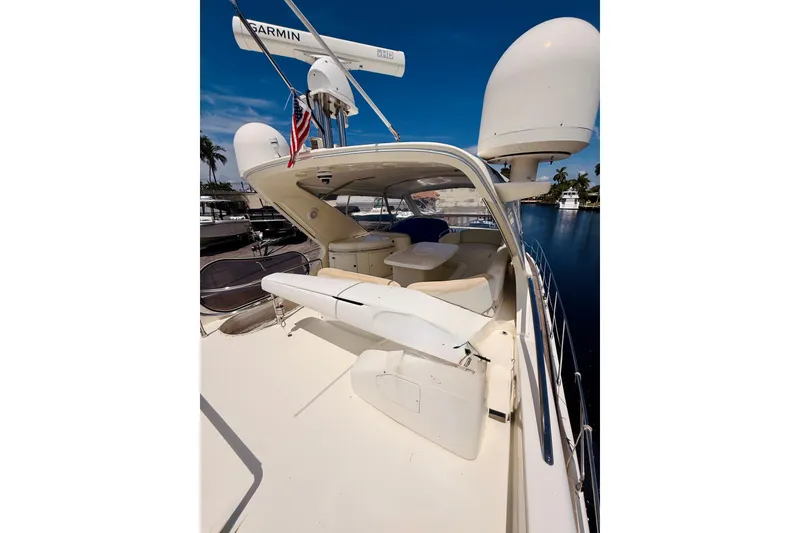 Slide: The Image of 2008 Azimut 62 yacht deck with seating, radar equipment, and American flag. - 2