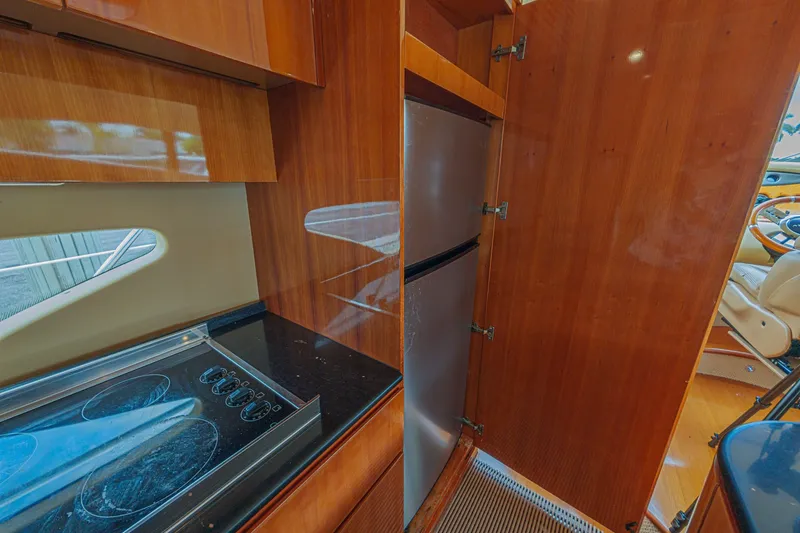 Slide: The Image of Luxurious 2008 Azimut 62 yacht kitchen with sleek wood cabinetry and modern appliances. - 28