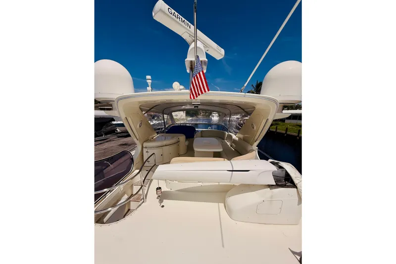 Slide: The Image of 2008 Azimut 62 yacht deck with seating, radar, and American flag. - 1