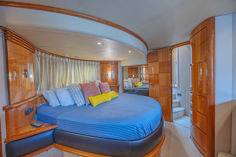 Slide: The Image of Luxurious bedroom interior of a 2008 Azimut 62 yacht with elegant wood finishes. - 52