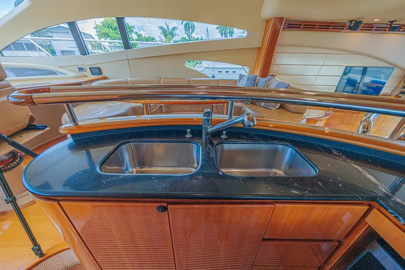 Slide: The Image of Luxurious interior of 2008 Azimut 62 yacht featuring sleek kitchen sink and elegant wood finishes. - 27