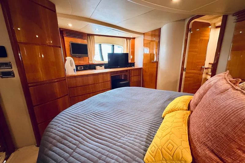 Slide: The Image of Luxurious 2008 Azimut 62 yacht bedroom with elegant wood finishes and modern amenities. - 55