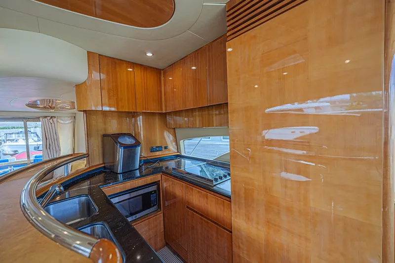 Slide: The Image of Luxurious kitchen interior of a 2008 Azimut 62 yacht with wood cabinetry and modern appliances. - 25