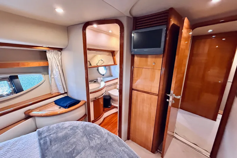 Slide: The Image of Luxurious interior of a 2008 Azimut 62 yacht featuring a cozy bedroom and bathroom. - 44